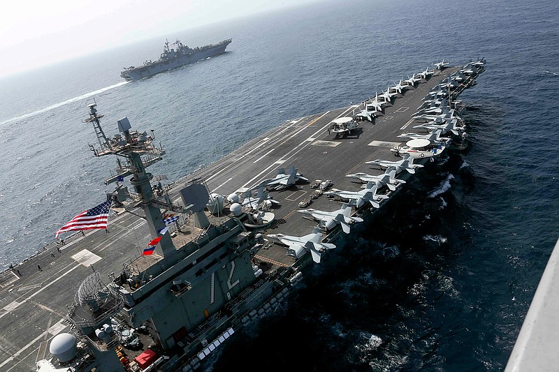  In this Friday, May 17, 2019, photo released by the U.S. Navy, the USS Abraham Lincoln sails in the Arabian Sea near the amphibious assault ship USS Kearsarge. Commercial airliners flying over the Persian Gulf risk being targeted by "miscalculation or misidentification" from the Iranian military amid heightened tensions between the Islamic Republic and the U.S., American diplomats warned Saturday, May 18, 2019, even as both Washington and Tehran say they don't seek war.