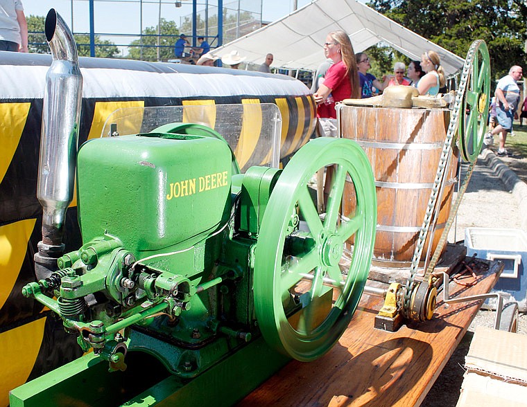 A 1927 John Deere engine grinds its gears to finish making homemade ice cream during the Russellville Engine Show and Festival on Saturday, June 10, 2017. Nathan Rackers, owner of the engine, reports the machine takes about 50 minutes to come up with a five-gallon batch of ice cream.