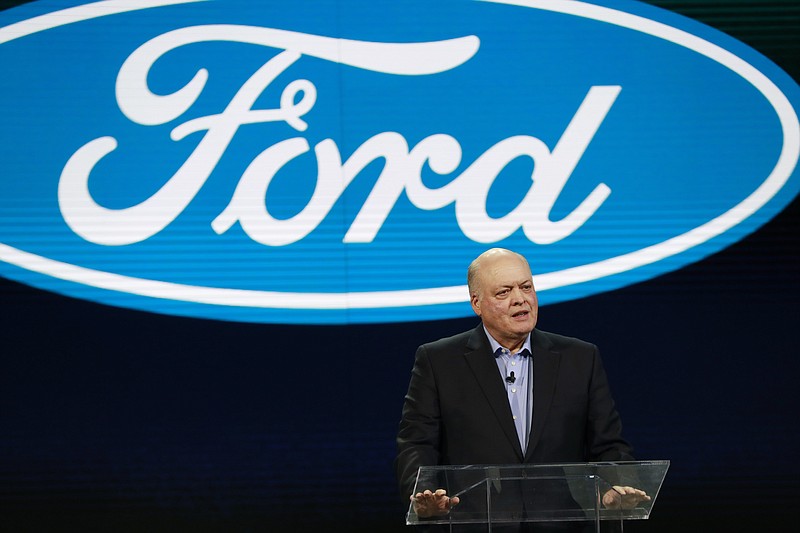 FILE - In this Jan. 14, 2018, file photo Ford President and CEO Jim Hackett prepares to address the media at the North American International Auto Show in Detroit. Ford is cutting about 7,000 white-collar jobs, which would make up 10% of its global workforce. The company has said it was undertaking a major restructuring, and on Monday, May 20, 2019, said that it will have trimmed thousands of jobs by August. In a memo to employees, Monday, Hackett said the fourth wave of the restructuring will start on Tuesday, May 21 with the majority of cuts being finished by May 24. (AP Photo/Carlos Osorio, File)