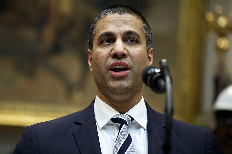 FILE - In this April 12, 2019 file photo, Federal Communications Commission Chairman Ajit Pai speaks during an event with President Donald Trump on the deployment of 5G technology in the United States, in the Roosevelt Room of the White House, in Washington. Pai says he plans to recommend the agency approve the $26.5 billion merger of wireless carriers T-Mobile and Sprint, saying it’ll speed up 5G deployment in the U.S. Pai also said Monday, May 20 that the combination will help bring faster mobile broadband to rural Americans. (AP Photo/Evan Vucci, File)