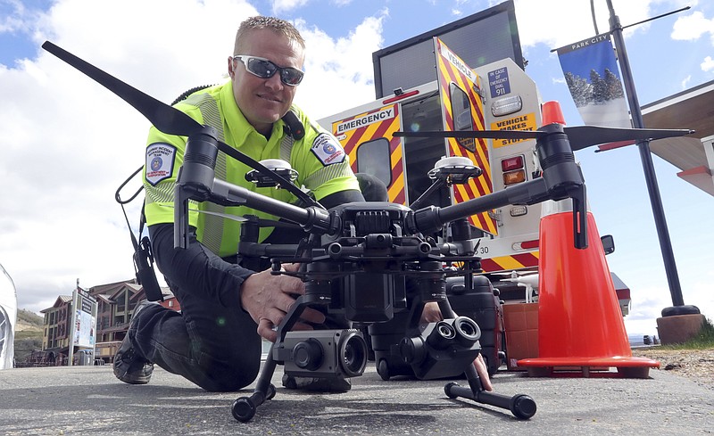 Travis White, Utah Department of Transportation, Highway Incident Management Team, holds their drone at a drone demo Monday, May 20, 2019, in Park City, Utah. In Utah, drones are hovering near avalanches to watch roaring snow. In North Carolina, they're searching for the nests of endangered birds. In Kansas, they could soon be identifying sick cows through heat signatures. Public transportation agencies are using drones in nearly every state, according to a new survey released on Monday, May 20, 2019 by the American Association of State Highway and Transportation Officials. (AP Photo/Rick Bowmer)