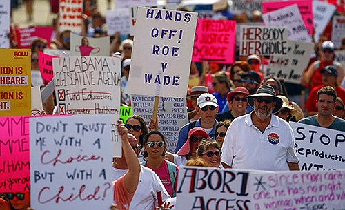 Protesters for women's rights march to the Alabama Capitol to protest a law passed last week making abortion a felony in nearly all cases with no exceptions for cases of rape or incest, Sunday, May 19, 2019, in Montgomery, Ala.