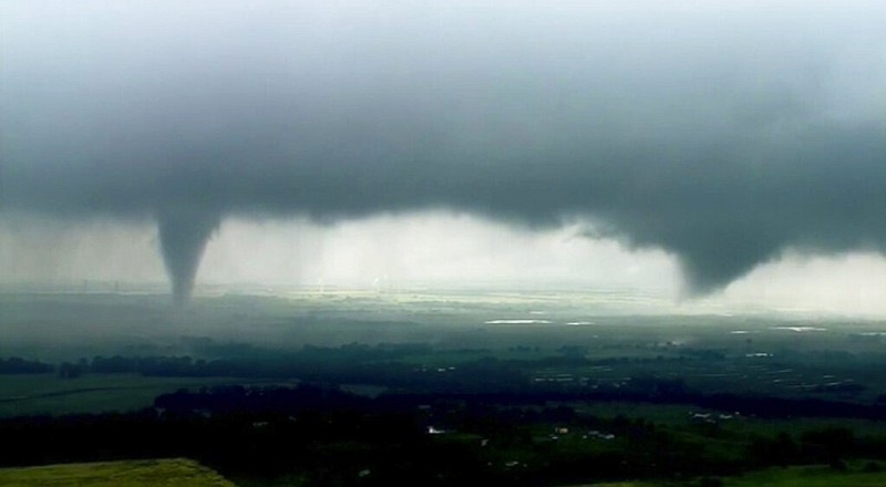 This image made from video provided by KWTV-KOTV shows two funnel clouds formed in Crescent, Okla., Monday, May 20, 2019. An intense storm system that weather forecasters labeled "particularly dangerous" swept through the Southern Plains Monday, spawning a few tornadoes that caused some damage and a deluge of rain but no reports of injuries. (KWTV-KOTV via AP)
