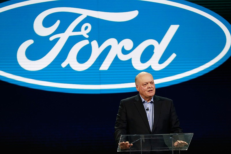 In this Jan. 14, 2018, file photo Ford President and CEO Jim Hackett prepares to address the media at the North American International Auto Show in Detroit. Ford is cutting about 7,000 white-collar jobs, which would make up 10% of its global workforce. The company has said it was undertaking a major restructuring, and on Monday, May 20, 2019, said that it will have trimmed thousands of jobs by August. In a memo to employees, Monday, Hackett said the fourth wave of the restructuring will start on Tuesday, May 21 with the majority of cuts being finished by May 24. (AP Photo/Carlos Osorio, File)