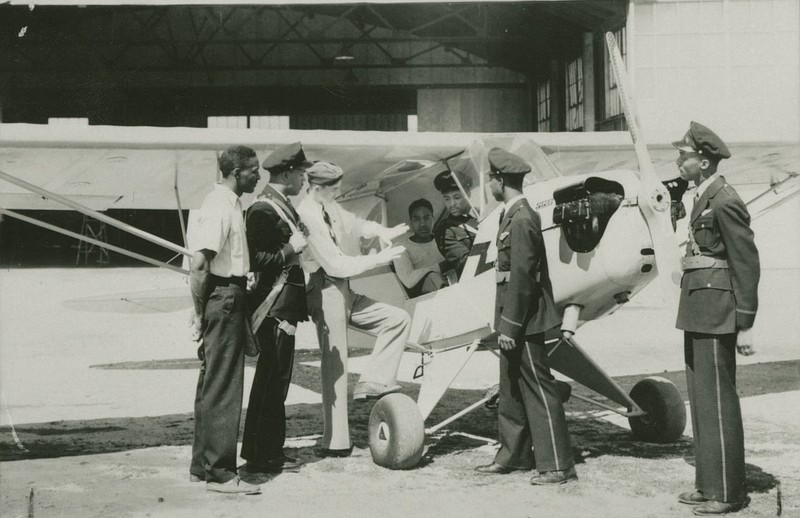 <p>Submitted</p><p>Student in the Civil Pilot and Flight Instruction program with instructors at Robertson Aircraft Corporation Flying Field in Jefferson City, in 1941 or 1942.</p>