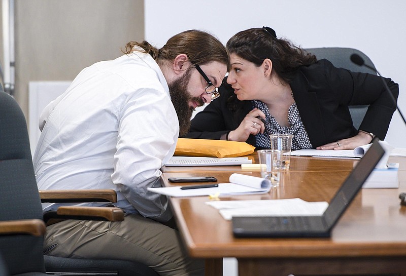 Steven Bourgoin confers with a member of his defense team during his murder trial in Vermont Superior Court in Burlington, Vt. on Tuesday, May 21, 2019. A jury has begun deliberations in the trial of the Vermont man facing murder charges in the deaths of five teenagers after he caused a head-on crash by driving the wrong way on an interstate. (Glenn Russell/VTDigger.org via AP, Pool, File)