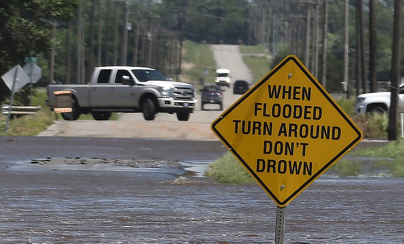 Traffic turns around as flood water covers 13th street in Kingfisher, Okla., Tuesday, May 21, 2019. (Billy Hefton/Enid News & Eagle via AP)