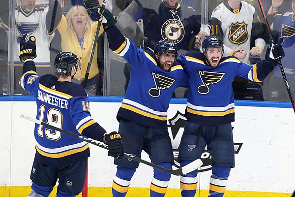 From left, Jay Bouwmeester, David Perron and Tyler Bozak of the Blues celebrate after Bozak scored a goal against the Sharks during the third period in Game 6 of the NHL Western Conference final Tuesday in St. Louis.