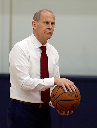 Cavaliers head coach John Beilein talks with players before a news conference Tuesday in Independence, Ohio. Beilein left Michigan after a successful 12-year run to coach the Cavaliers, who believe the 66-year-old can accelerate their rebuild.