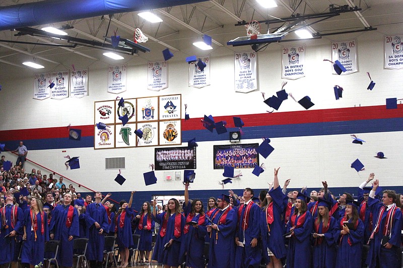 California High School 2019 graduates toss their graduation caps into the air to celebrate their completion of secondary education May 19 at California High School. 