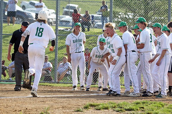 Ian Nolph (left) is greeted at home plate by his Blair Oaks teammates after hitting a solo home run in the fourth inning of Wednesday's Class 3 quarterfinal game against Lawson at the Falcon Athletic Complex.