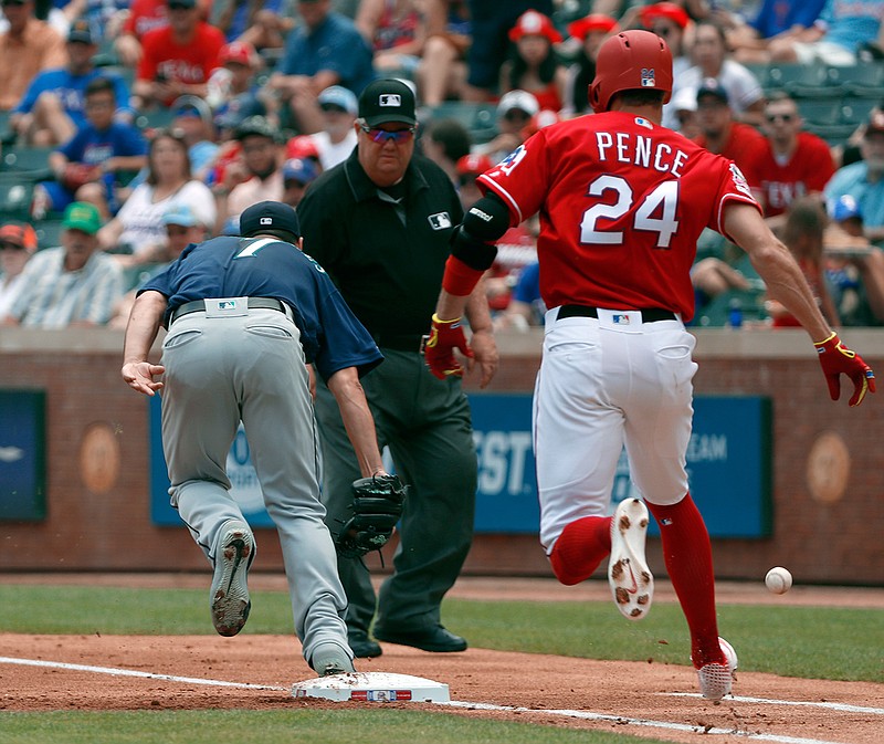 Seattle Mariners starting pitcher Marco Gonzales (7) is unable to reach the throw to the bag allowing Texas Rangers' Hunter Pence (24) to reach first on a throwing error by Edwin Encarnacion, not pictured, as umpire Joe West watches in the first inning of a baseball game in Arlington, Texas, Wednesday, May 22, 2019. Pence advanced to second on the play. (AP Photo/Tony Gutierrez)