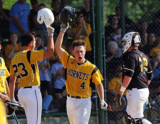 Coltin Green (4) celebrates with St. Elizabeth teammate Dylan Wobbe after hitting a two-run home run in the first inning of Wednesday's Class 1 quarterfinal game against Wellsville in St. Elizabeth.