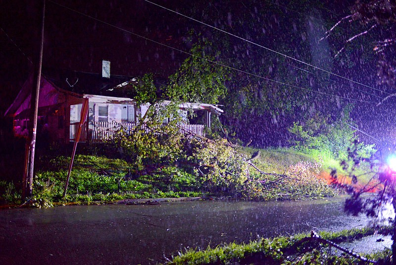 Debris is spread across the front lawn of a home along Adams Street Thursday, May 23, 2019, after a tornado hit Jefferson City at approximately 11:45 p.m. Wednesday.