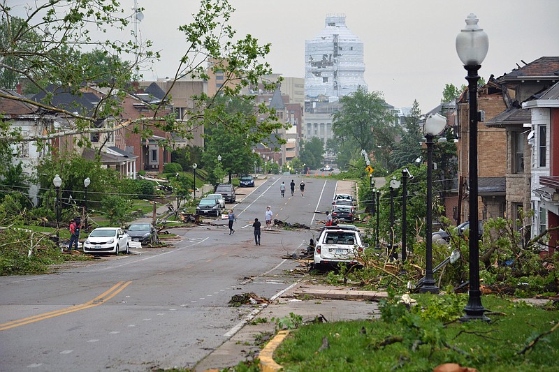 Sally Ince/ News Tribune
Residents observe damaged cars and homes Thursday May 23, 2019 after a tornado caused savere damage along both sides of Capitol Avenue. The National Weather Service has ruled Wednesday’s tornado as an EF-3, with peak winds reaching 160mph.