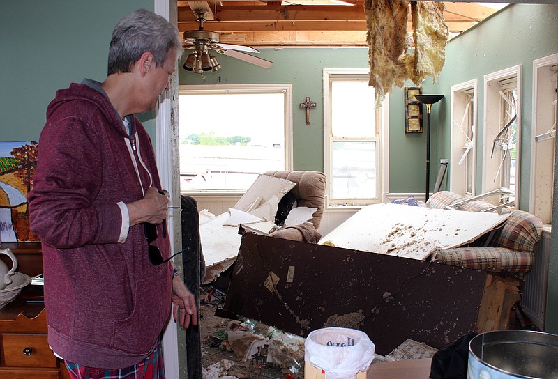 Rebecca Martin/News Tribune
Janet Smyer looks at toppled furniture in the family room of her home on Heritage Highway on Thursday, May 23, 2019, after a tornado hit the area south of Jefferson City late Wednesday.