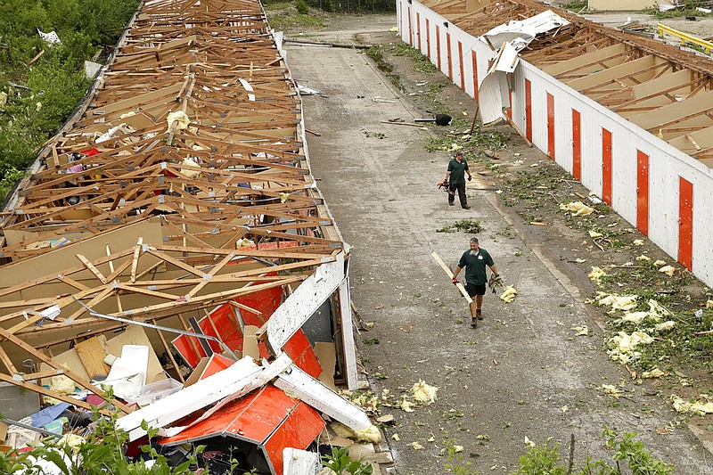 Workers pick up debris at destroyed storage units Thursday, May 23, 2019 after a tornado tore though Jefferson City, Mo. late Wednesday. (AP Photo/Charlie Riedel)