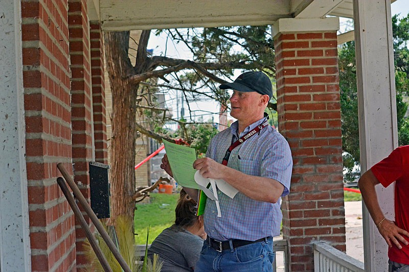Building inspector Daryl Brown, of Columbia, places a notice of structural inspected on a door Friday May 24, 2019 deeming the Jefferson City house on Capitol Avenue safe for occupancy. Jefferson City building inspectors are being assisted with tornado recovery through a mutual aid agreement with members of the Structural Assessment and Visual Evaluation (SAVE) Coalition.