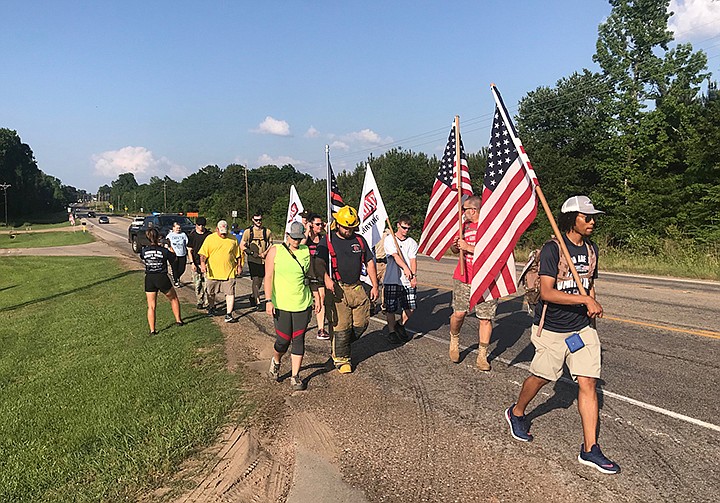 Branden Fox from Indianapolis, a member of Carry the Load, leads a 5-mile segment of the 3,800-mile journey Thursday in Texarkana. Photo by Tom Morrissey