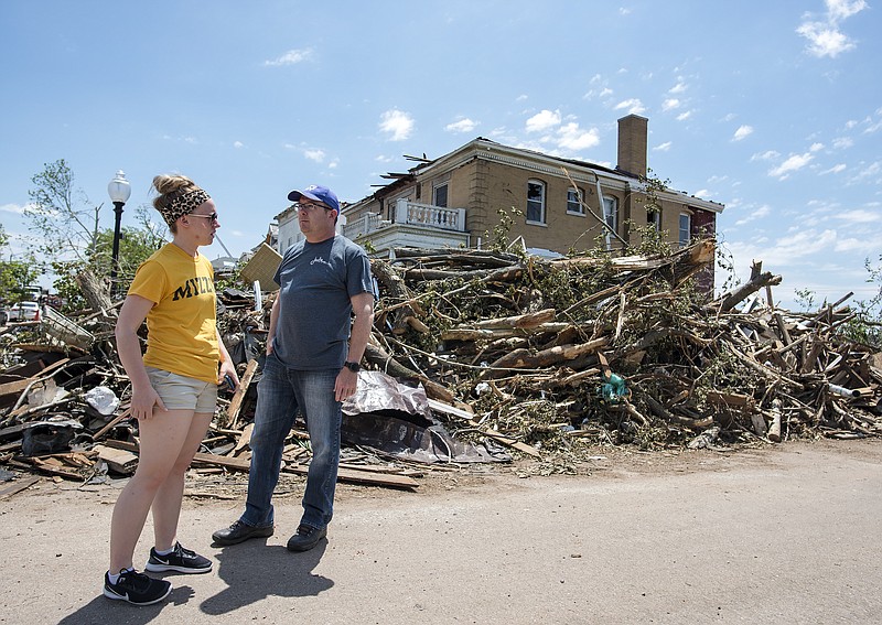 Jessica Haslag, left, and KRCG meteorologist Zach Paul survey the tornado damage near the historic Dallmeyer House at the corner of Marshall Street and East Capitol Avenue while touring the historic district Saturday afternoon, May 25, 2019.