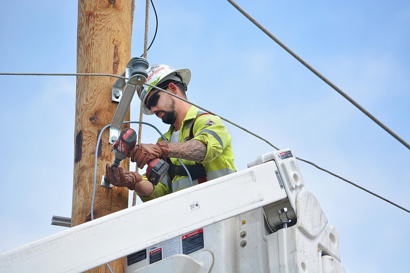 Ameren utility worker Tyler Hudson, of St. Louis, installs an electrical wire Friday, May 24, 2019 as Jefferson City begins to repair damages caused by the May 22 tornado. 