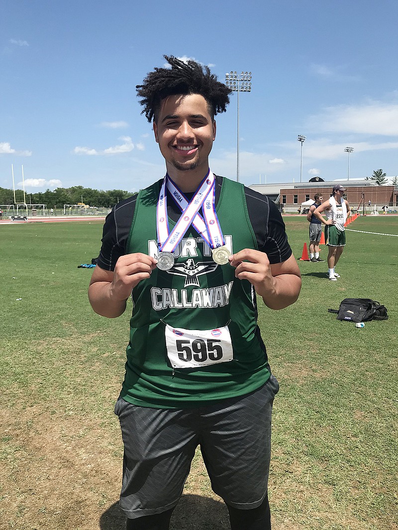 North Callaway senior Paden Lewis displays his medals after winning a state title in the shot put and finishing second in the discus in the Class 3 state track and field championships Saturday at the University of Missouri's Walton Stadium in Columbia.