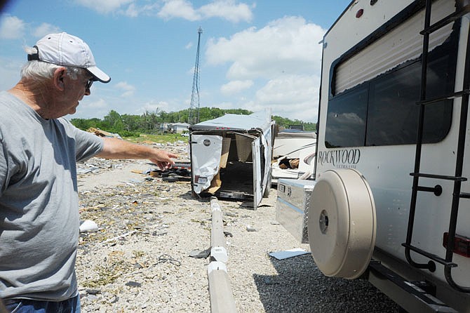 Charlie Bowman identifies the damage to the camper next to his. He was in disbelief his camper was in one piece.