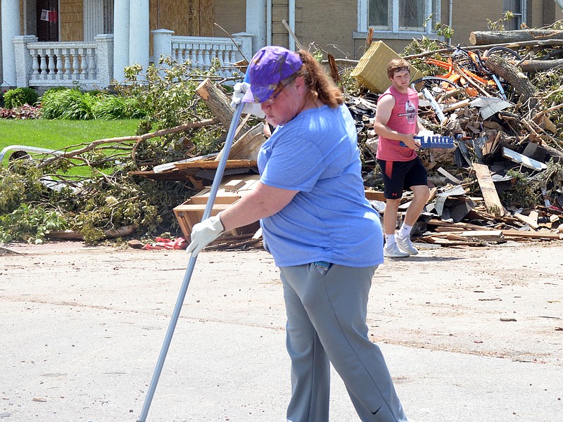 
Rebecca Overman cleans up debris Saturday, May 26, 2019, along Capitol Avenue following the Wednesday nght tornado that rolled through Jefferson City.