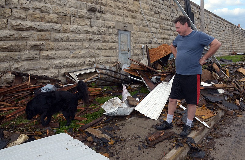 Frank Denton and Oliver walk down Lafayette Saturday, May 25, 2019 and survey tornado damage at the Missouri State Penitentiary following the Wednesday night storm that rolled through town. Denton said that Oliver slept through the tornado.