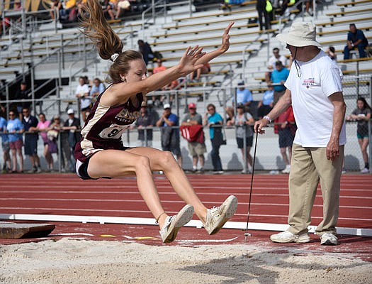 Caroline Beckmann of Eldon leaps towards the sand while competing in the long jump Saturday in the Class 3 state track and field championships at Walton Stadium in Columbia.