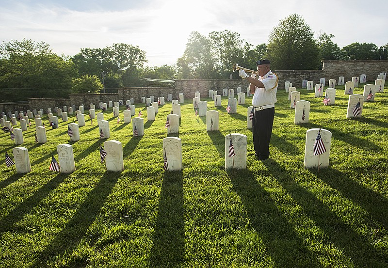 Retired U.S. Army 1st Sgt. J.B. DeWesplore of the Veterans of Foreign Wars Basinger/Sone Memorial Post 1003 Honor Guard plays "Taps" on his bugle following a 21-gun memorial salute during Sunday's annual Memorial Day Program at the Jefferson City National Cemetery. The event was hosted and sponsored by the Jefferson City Veterans Council.