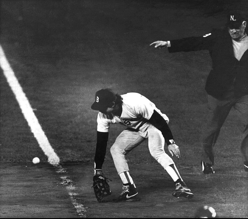 In this Oct. 25, 1986, file photo, Boston Red Sox first baseman Bill Buckner misplays the ball during during Game 6 of the World Series against the New York Mets. Buckner, a star hitter who became known for making one of the most infamous plays in major league history, has died. He was 69. Buckner's family said in a statement that he died Monday, May 27, 2019, after a long battle with dementia. (Stan Grossfeld/The Boston Globe via AP, File)