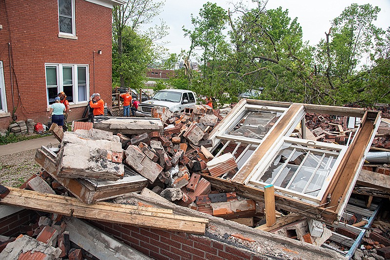 The home in the background, owned by Tracy Johnson, stands next door to a house reduced to rubble during the tornado that hit Jefferson City on Wednesday night, May 22, 2019. She was grateful for this turnout of volunteers Monday, May 27, to help with cleaning up, cutting trees and more.