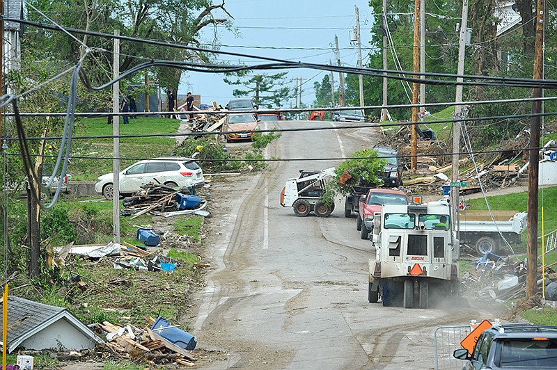 Despite it being a government holiday, many volunteers and paid workers were hard at it Monday, May 27, 2019, cleaning up after Wednesday night's tornado in Jefferson City. Looking north from Jackson Street at Woodlawn, this view of the 800 to 1000 block of Jackson and Adams streets shows the path of destruction.