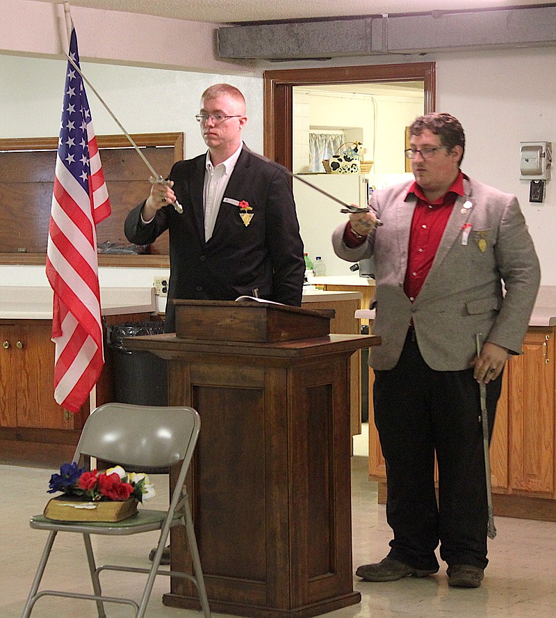 <p>honor veterans Democrat photo/Liz Morales</p><p>Daniel Sutton and Casey Pemberton conduct a Knights of Pythius ceremony to honor fallen veterans and master masons at the May 27 Memorial Day Observance at the Masonic Lodge.</p>