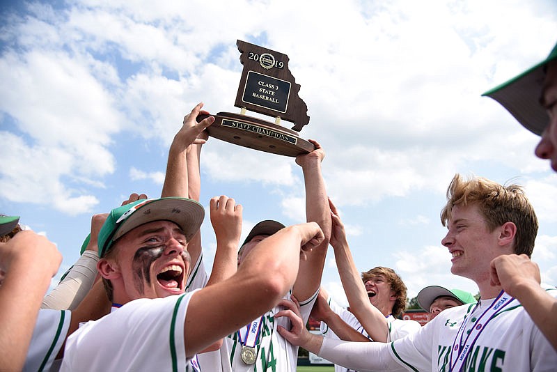 The Blair Oaks Falcons holds up the state championship trophy after winning Tuesday's Class 3 state championship game against Fatima at CarShield Field in O'Fallon. 