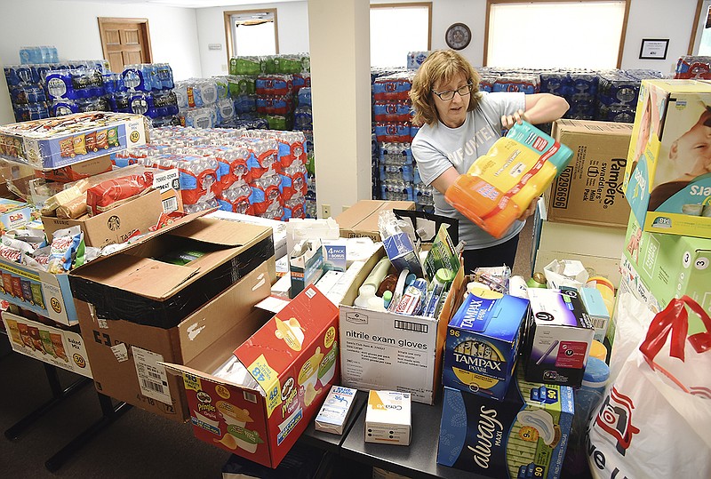 United Way of Central Missouri Vice President Theresa Verslues sorts through and separates items donated for distribution for those affected by the May 22, 2019, tornado. These items and many more will be housed at Capital West Christian Church Event Center for distribution.