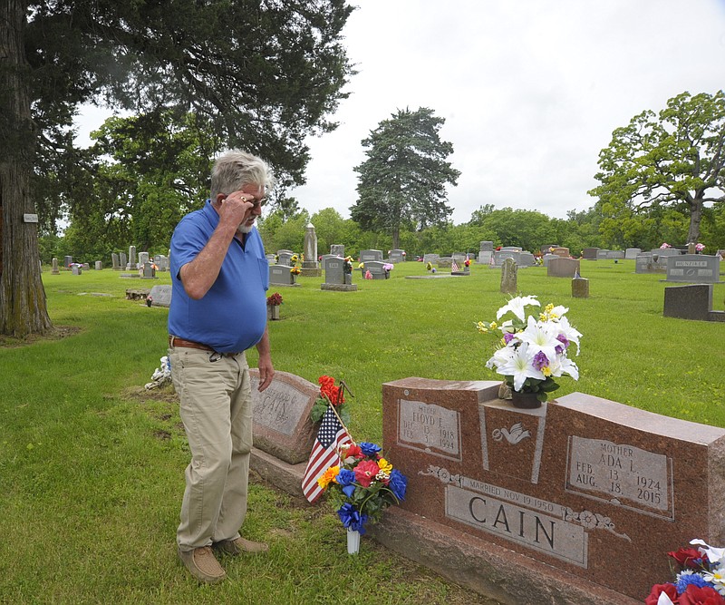 <p>Danisha Hogue/News Tribune</p><p>Floyd Cain observes his parents graves over Memorial Day weekend.</p>