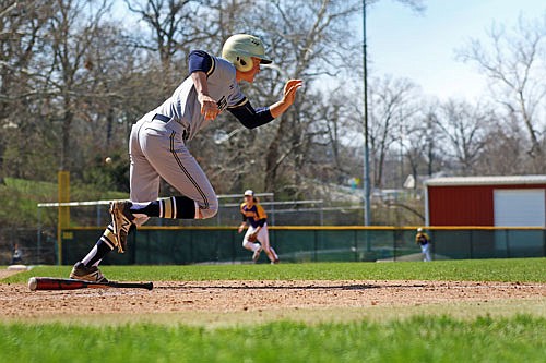 Helias' Zach Woehr runs down the first-base line after hitting a ground ball during the third-place game of the Capital City Invitational on April 6 at Vivion Field. The Crusaders will face Borgia in the Class 4 semifinals at 4 p.m. today at CarShield Field in O'Fallon.