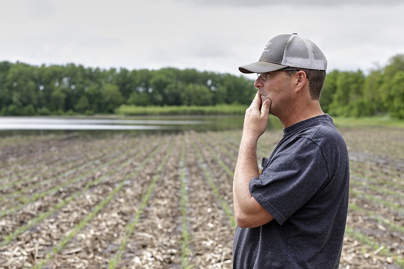 In this May 29, 2019 photo, Jeff Jorgenson looks over a partially flooded field he farms near Shenandoah, Iowa. About a quarter of his land was lost this year to Missouri River flooding, and much of his remaining property has been inundated with heavy rain and water from the neighboring Nishnabotna River. (AP Photo/Nati Harnik)