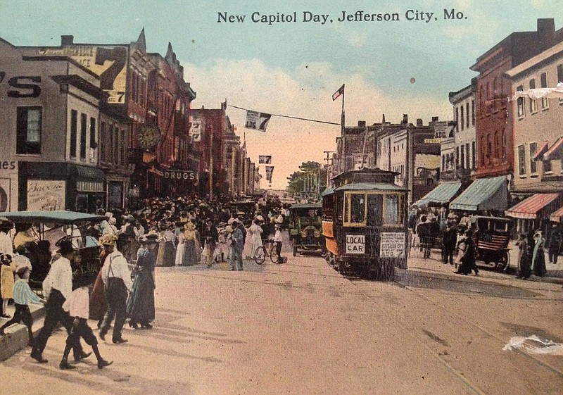 <p>A colorized photo shows a streetcar on High Street, looking west from the 200 block. The city is packed with celebrants in town for the dedication of the new Capitol building.</p>