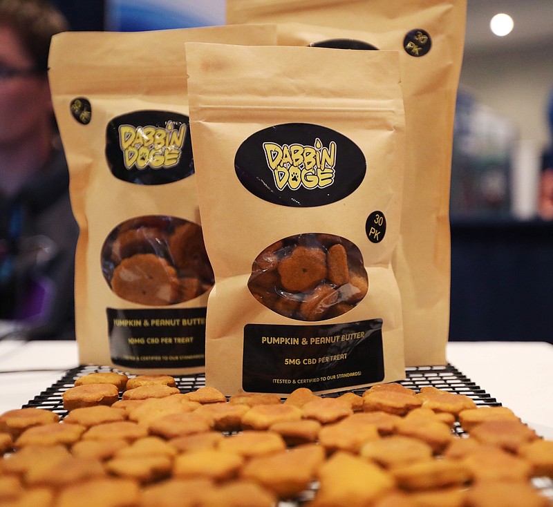 Dog treats are displayed at the Cannabis World Congress & Business Exposition trade show, Thursday, May 30, 2019 in New York. The treats contain non-psychoactive cannabidiol, CBD. They are marketed by DabbinDoge of New Providence, N.J. (AP Photo/Jeremy Rehm)
