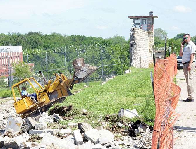 Workers clean up debris at the Missouri State Penitentiary following the May 22, 2019, tornado that swept through Jefferson City.