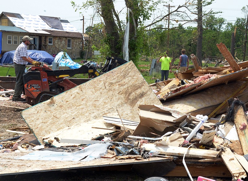 Mark Wilson/News Tribune
Workers clean up substantial damage at the Twin Bridges Mobile Home Village located on the Heritage Highway Saturday.