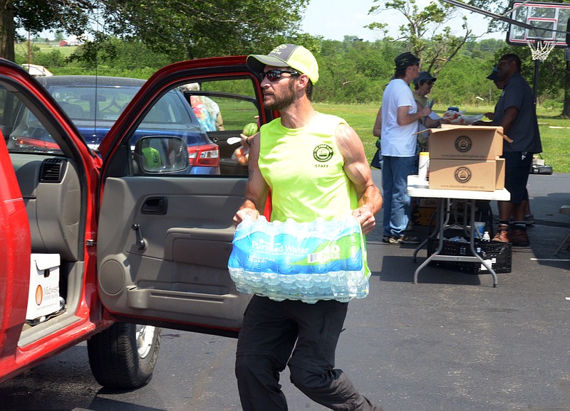 Mark Wilson/News Tribune
Volunteers hand out supplies at the MARC Center in Eldon Saturday. Multi-Agency Resources Center (MARC) is designed to be a one stop shop where public and private relief agencies offer services to disaster victims.