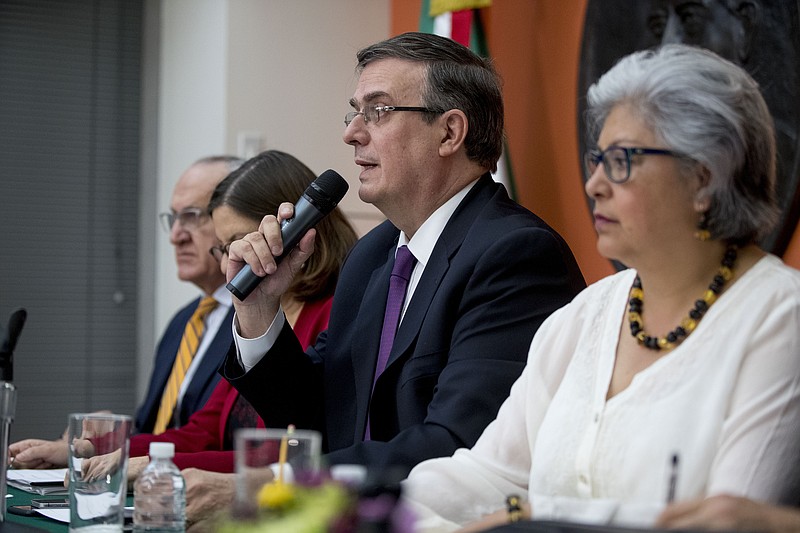 Mexican Foreign Affairs Secretary Marcelo Ebrard, center, speaks at a news conference at the Mexican Embassy in Washington, Monday, June 3, 2019, as a Mexican delegation arrives in Washington for talks following trade tariff threats from the Trump Administration. (AP Photo/Andrew Harnik)