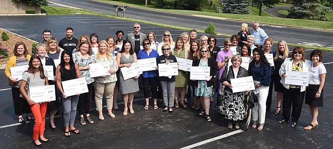 Representatives from 25 local agencies, including 12 United Way partner agencies, receive community support grants Tuesday from the United Way of Central Missouri at the Senior Nutrition Council of Jefferson City and Cole County. 