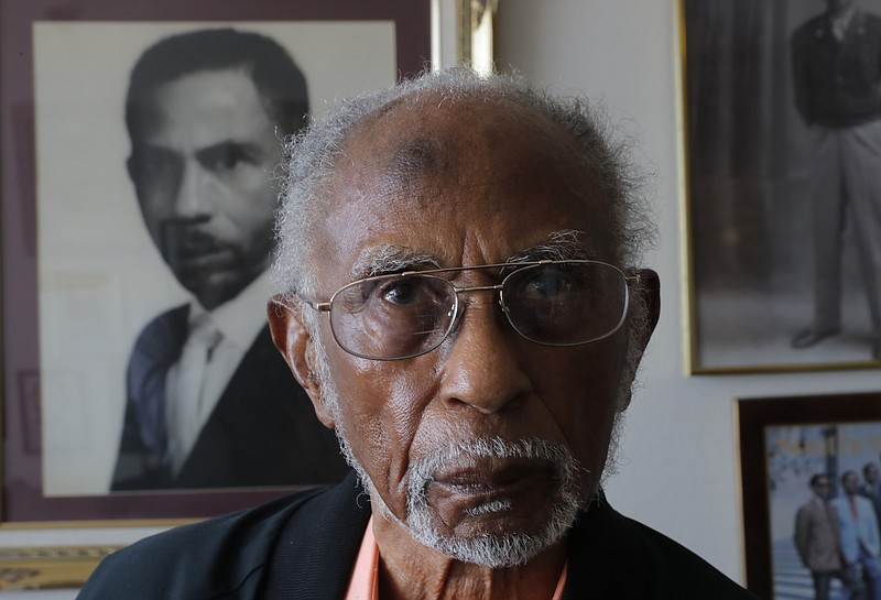 World War II veteran Johnnie Jones, Sr. poses for a portrait at his home in Baton Rouge, La., Tuesday, May 28, 2019. Jones, who joined the military in 1943 out of Southern University in Baton Rouge, was a warrant officer in a unit responsible for unloading equipment and supplies onto Normandy. He remembers wading ashore and one incident when he and his fellow soldiers came under fire from a German sniper. He grabbed his weapon and returned fire along with the other soldiers. It's something that still haunts his memories. (AP Photo/Gerald Herbert)