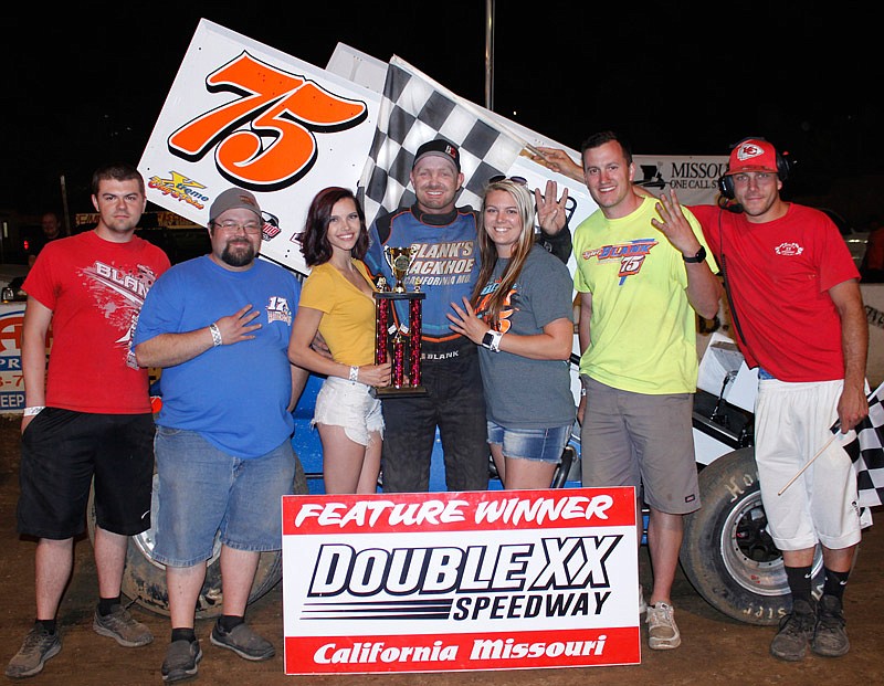 California's Tyler Blank won his fourth race in a row. Blank is pictured with crew members of his 360 winged sprint with girlfriend Kelsey Brauner to his left. Meghan Sumner of Versailles presents the trophy aided by Double-X Director A.J. Wirts. (Courtesy of Carol Wirts)