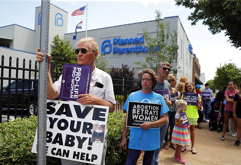 Anti-abortion advocates gather outside the Planned Parenthood clinic Tuesday, June 4, 2019, in St. Louis. 